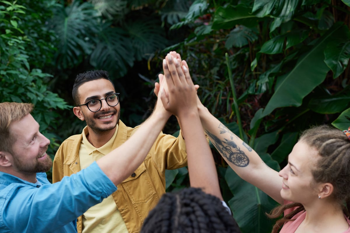 Photo Of People Standing Near Plants